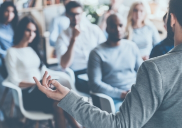 People sitting in the audience of a seminar